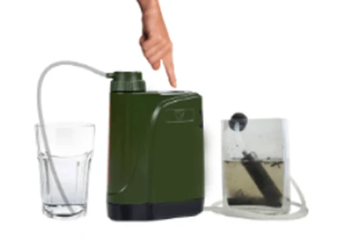 Survivor Filter Pro X electric water filter in use, filtering water from a collection bag into a drinking glass